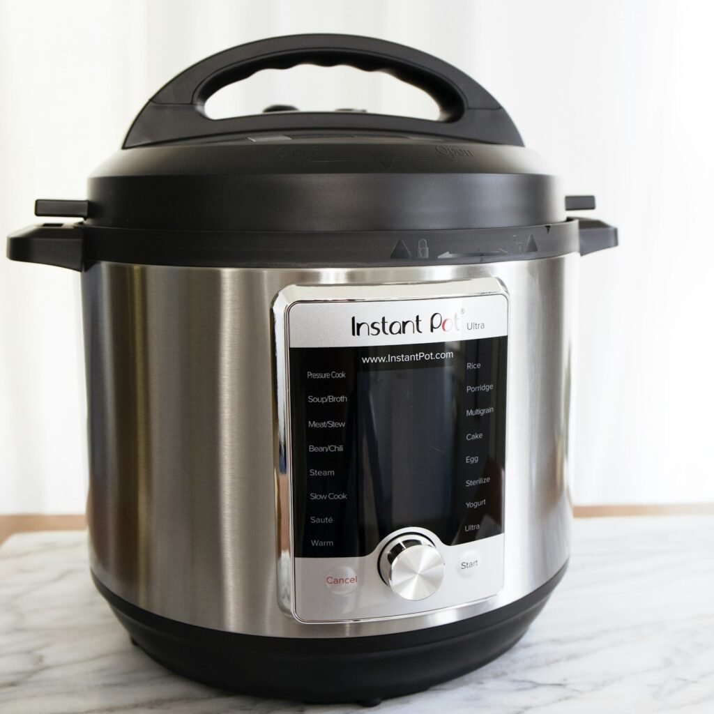 Stainless steel Instant Pot electric pressure cooker on a marble counter