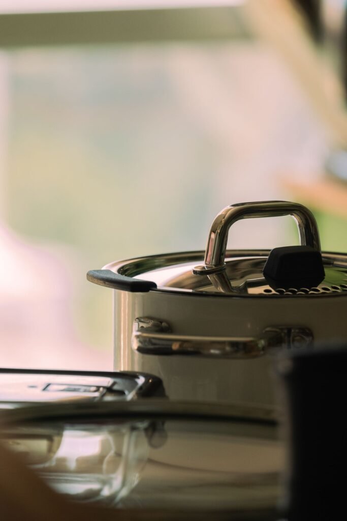 Stainless steel pot with a lid on a kitchen counter